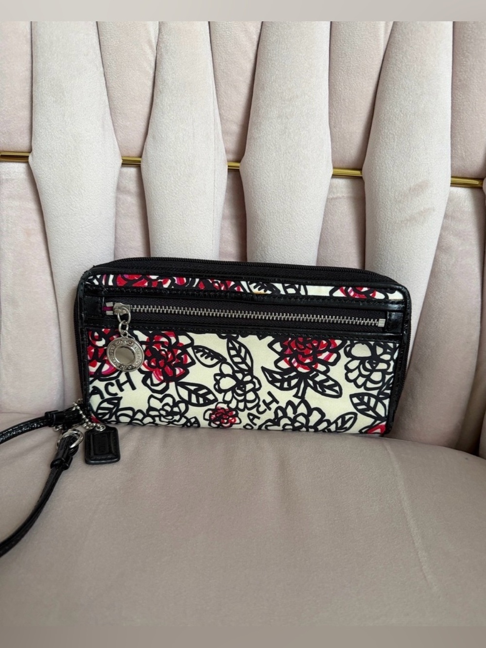 Coach Poppy Daisy Graffiti wristlet featuring a black and white floral print